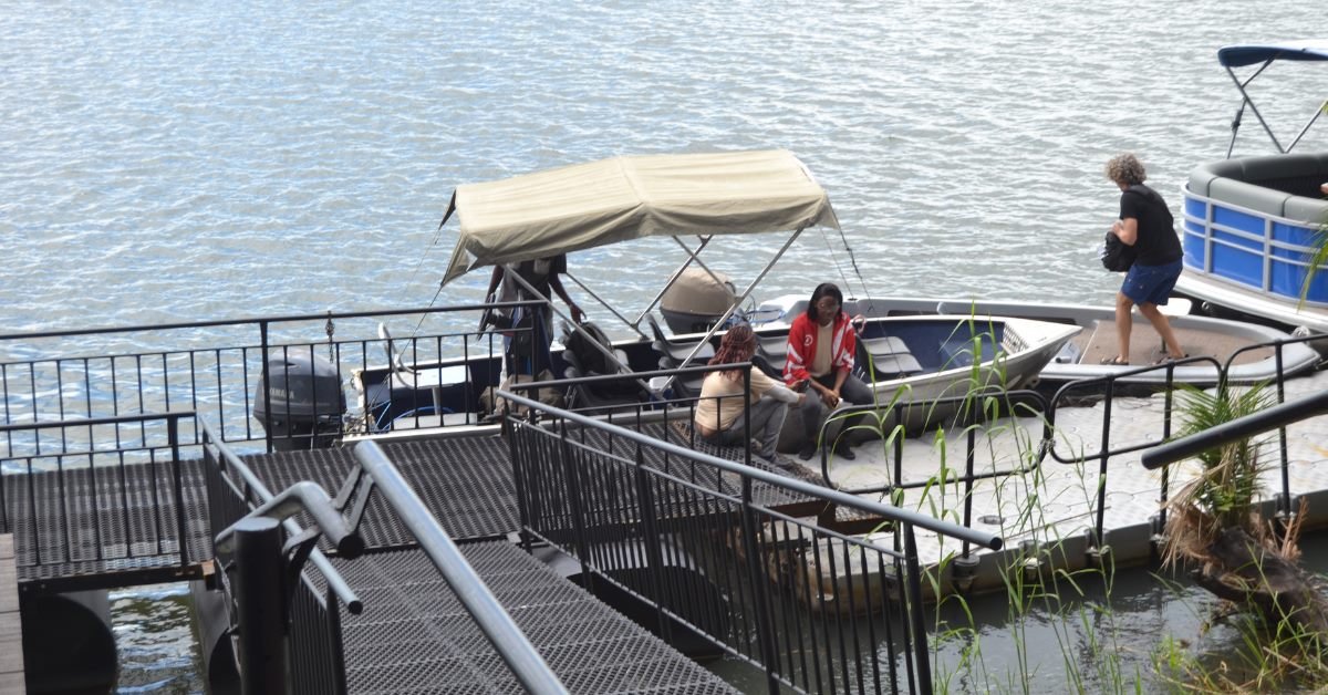 Travelers boarding a river cruise boat during a cross-border Chobe safari