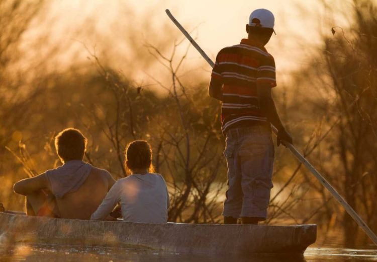 Mokoro canoe at sunset on the Okavango Delta, Botswana