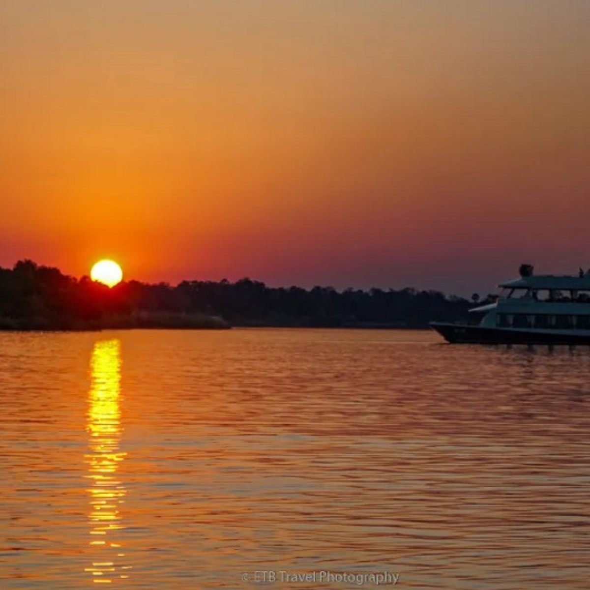 Zambezi River sunset cruise boat silhouette near Victoria Falls